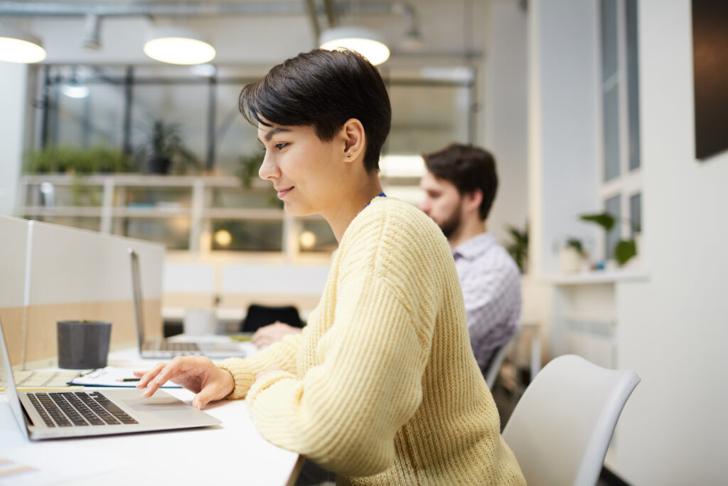 A young woman with good professional skills working inside the office.